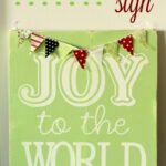 Joy to the World Sign Tutorial!! This is such a cute and easy sign to make! Supplies include wood, vinyl, paint, and fabric pieces!