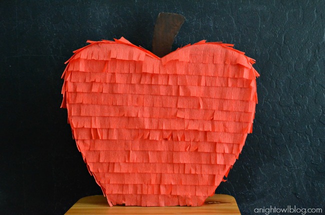 Teacher's Apple Piñata Tutorial on { lilluna.com } So cute and easy to make! Supplies include cardboard, red streamers, & brown paint!!