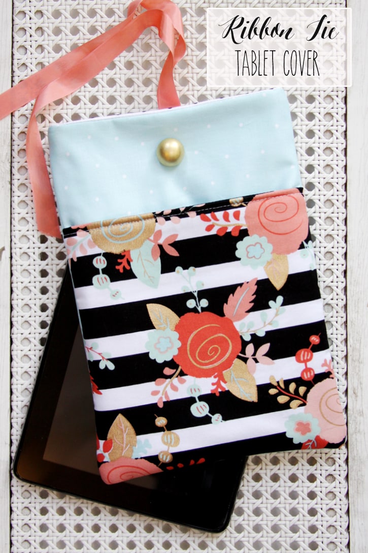 DIY Ribbon Tie Tablet Cover - SO CUTE!! It's the perfect gift idea for the friend or family member who can't live without their tablet. All you need is some cute fabric, fusible fleece, a button, ribbon, and some basic sewing supplies!