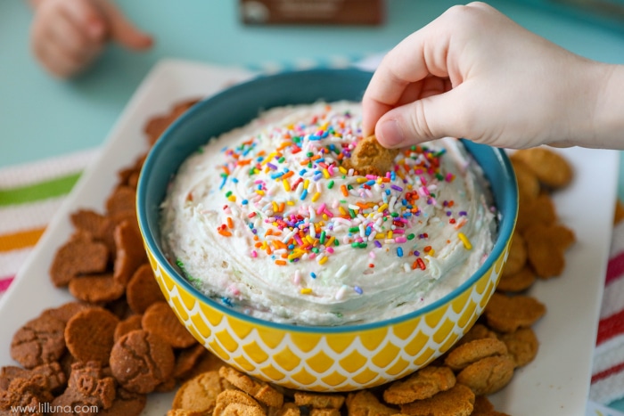 cookie being dipped in funfetti dip