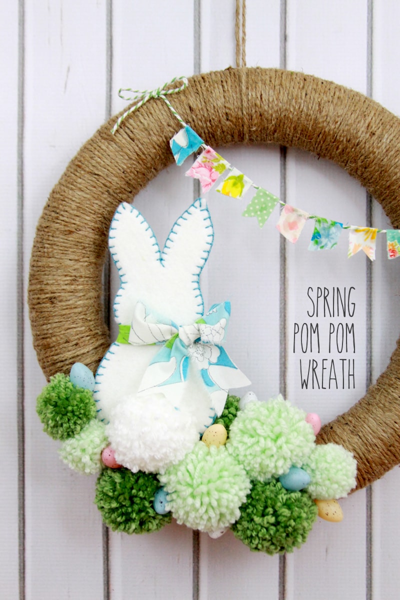 Spring Pom Pom Wreath - so cute! Tutorial on { lilluna.com } Supplies include a foam wreath, fabric, yarn, twine, felt, and mini Easter eggs.