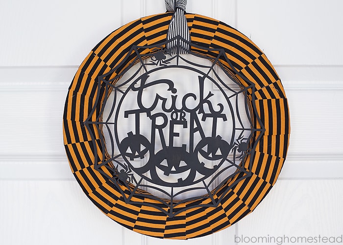 Trick or Treat Halloween Wreath hanging on a door. 
