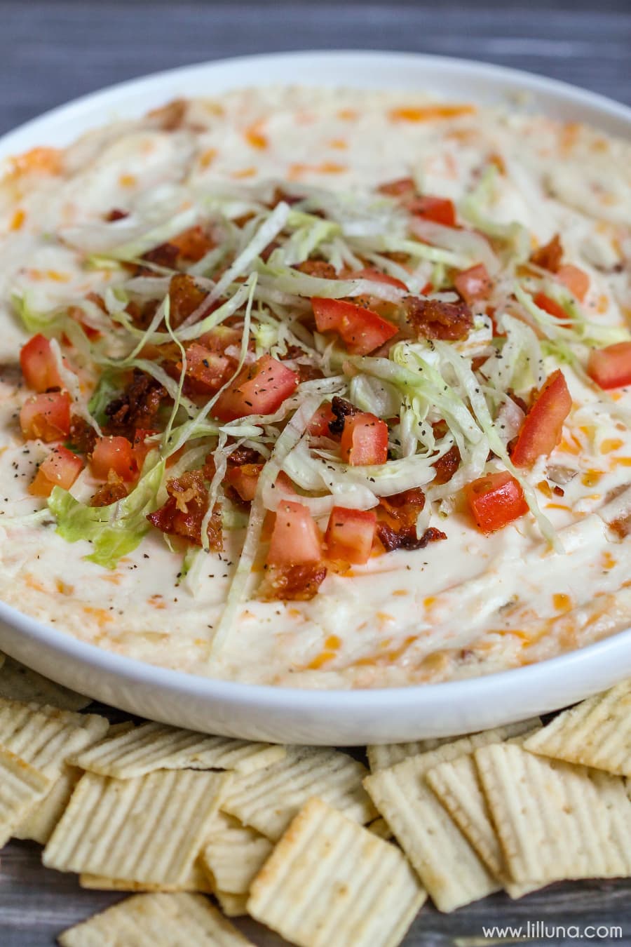 BLT Dip - one of our favorite appetizers! It's loaded with cream cheese, cheese and sour cream and topped with bacon, lettuce and tomato!!