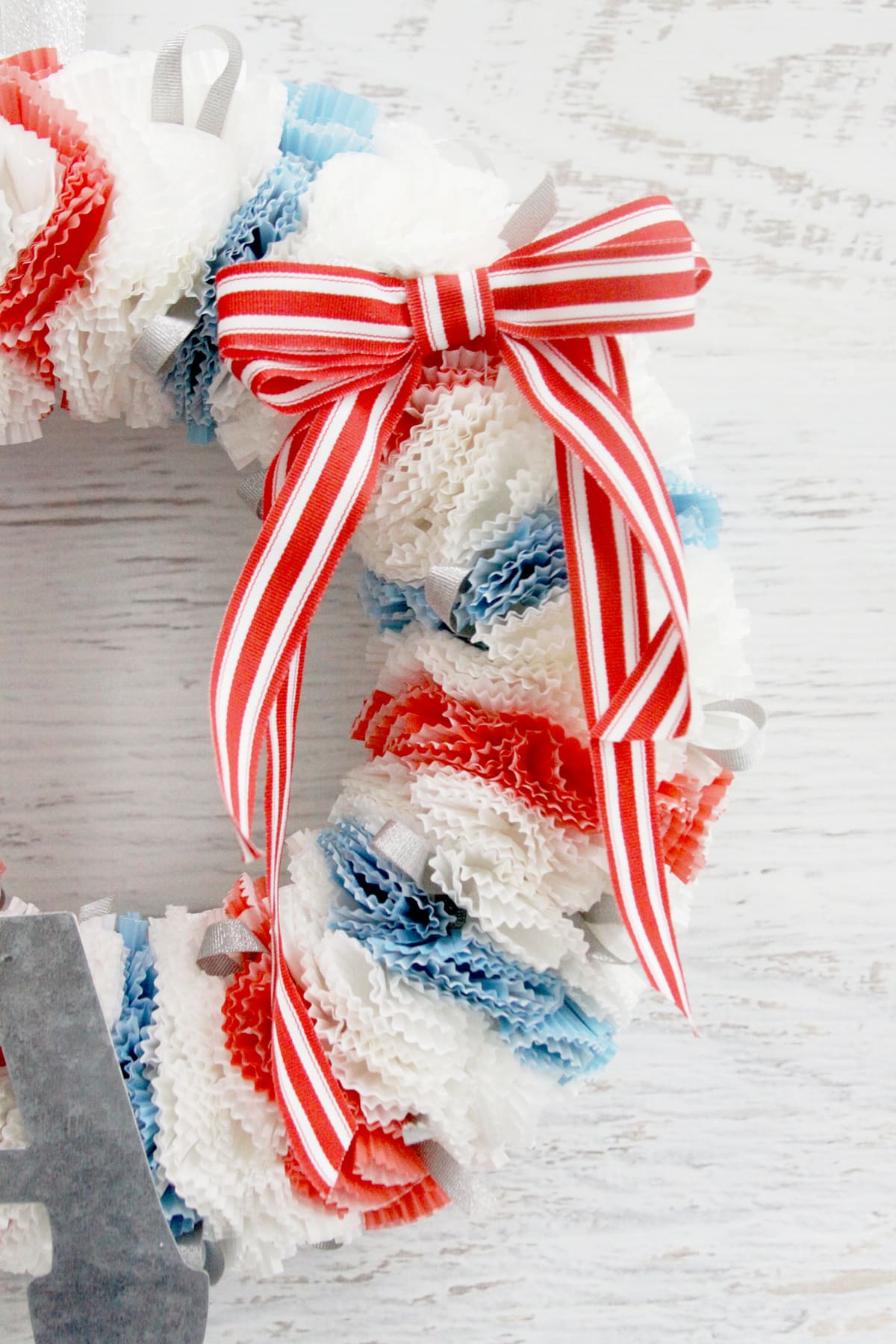 Fourth of July Wreath - this cupcake liner wreath is so easy to make! All you need is a wreath form, cupcake liners, pins, and ribbon - perfect for the 4th!